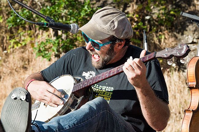 Marcus Larson/News-Register##Musician Konrad Wert, who performs under the moniker Possessed by Paul James, shreds the banjo and kicks his heels up onstage at the 6th annual Wildwood MusicFest & Campout on Saturday at the Roshambo Art Farm.