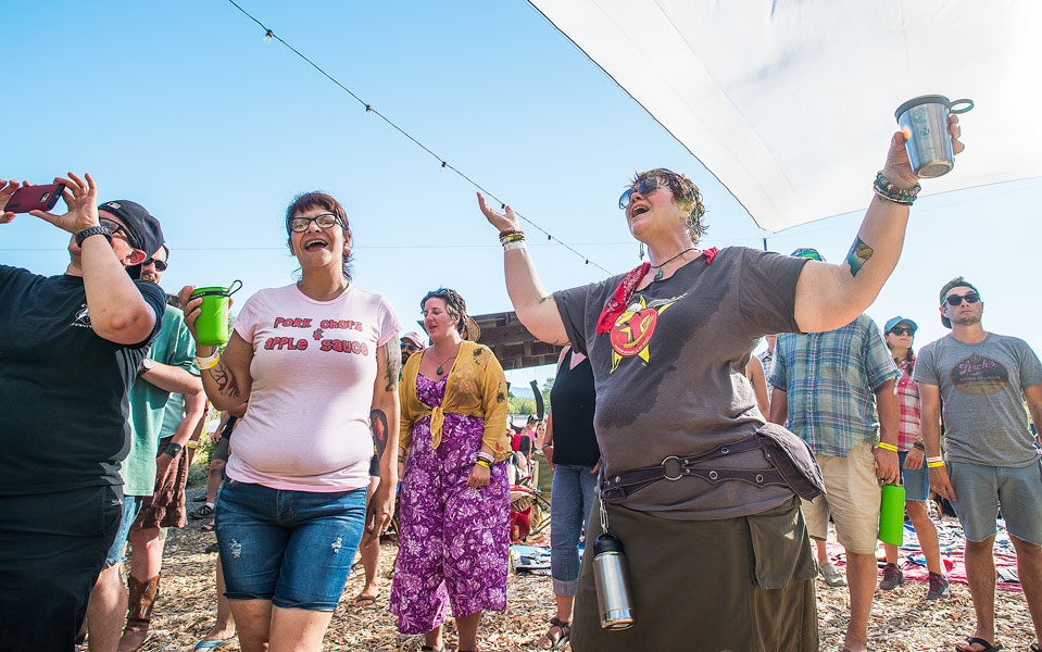 Marcus Larson/News-Register##Lisa Miyamoto, right, and other fans cheer for the band The Harmed Brothers at the Wildwood Music Festival. Marcus Larson/News-Register##Lisa Miyamoto, right, and other fans cheer for the band The Harmed Brothers at the Wildwood Music Festival.