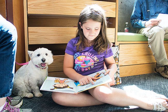 Anna Lieberman/ News-Register##
Tabatha Jordan, 8, quietly reads a book to therapy dog Summer, who often wags her tail or sniffs the pages.