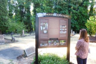 Starla Pointer / News-Register##Molly Casperson of the BLM takes a look at the Brookside Cemetery s new sign.