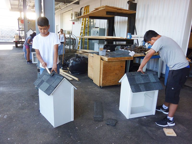 Starla Pointer / News-Register##Dominic Corero, left, nd Julio Partida roof a paif of the little libraries.