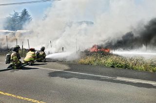 Submitted photo / Sheridan/Southwest Polk/West Valley fire districts##
Firefighters spray water an auto storage yard and outbuildings ablaze
burned along Highway 18 in Grand Ronde Wednesday afternoon. About the
same, other crews were fighting wildland fires near the casino. Submitted photo / Sheridan/Southwest Polk/West Valley fire districts##
Firefighters spray water an auto storage yard and outbuildings ablaze
burned along Highway 18 in Grand Ronde Wednesday afternoon. About the
same, other crews were fighting wildland fires near the casino.