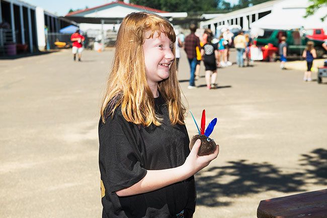 Rusty Rae/News-Register##
Sophie Bingman, who will enter fifth grade this fall at Amity grade school, completes her  dirt dolly  Wednesday morning at the Ag Education Center at the Yamhill County Fair. Planted with grass seed, the  dolly  soon will have green hair.
