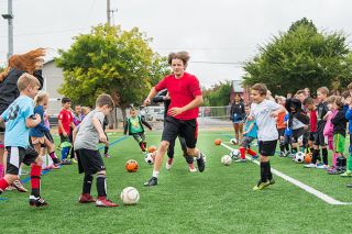 Marcus Larson/News-Register##
Student coach Devin Lawson tries running through a gauntlet of kicked soccer balls without getting hit on the final day of the MHS Grizzly Youth Soccer Camp. Marcus Larson/News-Register##
Student coach Devin Lawson tries running through a gauntlet of kicked soccer balls without getting hit on the final day of the MHS Grizzly Youth Soccer Camp.