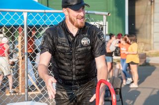 Rusty Rae/News-Register file photo##A drenched Yamhill County Sheriff’s Office K-9 deputy Nathan Skaer emerges from the dunk tank during Willamina’s National Night Out celebration. Below: Firefighter/medics Jay Payne and Ryan Vauble and firefighter Steven Brown, left to right, serve up hot dogs.