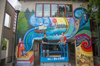Rusty Rae/News-Register##Artists Elide Rivera Sanchez, left, and Allison McClay put the final touches on the new SMART mural at McMinnville Public Library. It will be dedicated at 1:30 p.m. Sunday, Aug. 14.