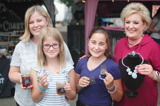 Kirby Neumann-Rea/News-Register ## Entrepreneurs Maddie Rohloff and Karis Miller, front, with Heidi Rohloff and Cindy Johnson, in front of the Hood To Coast and Sugar Bling Sisters booths at the Yamhill County
Fair.