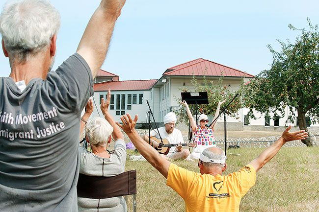 Kelsey Richmond photo##Daniel Gurucharan Tabachnick plays the guitar for a chant he is leading with Hardev Kaur at a combined worship service and protest at the federal prison in Sheridan where 123 refugees have been detained.