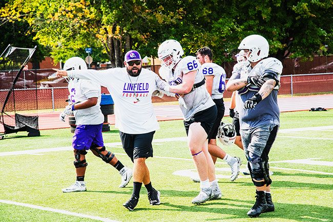 Rusty Rae/The News-Register##
Offensive line coach Will Heck directs Alex Hankins during drills at Wednesday’s practice.