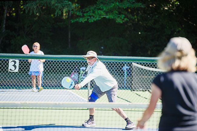 Rusty Rae/News-Register##
Mark Pinto of McMinnville stretches to return a shot from Lori Wallick during a match Tuesday morning at the City Park pickleball courts.
