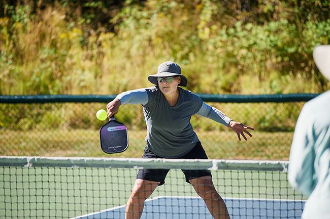 Rusty Rae/News-Register##
Christine Sterr, visiting from Roseville, California, send the ball back over the net during a game.