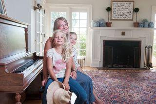 Rusty Rae/News-Register ## Addilyn and Savanna Haney join their mom, Darci, at the family piano in the living room of Westerlook. Darci, who owned MD Haney home décor store in McMinnville, is in the process of decorating the space.