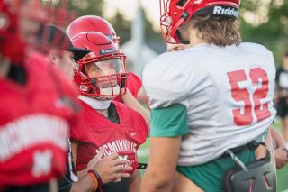 Rusty Rae/News-Register##
Starting McMinnville running back Austin Rapp discusses a play with Landon Fay during Tuesday’s training cam at Wortman Stadium.