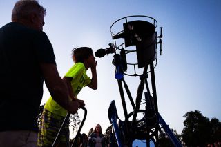 Marcus Larson/News-Register##Sawyer Cook peers through a giant telescope, which allows him to see Jupiter during an evening star party in Carlton. Marcus Larson/News-Register##Sawyer Cook peers through a giant telescope, which allows him to see Jupiter during an evening star party in Carlton.