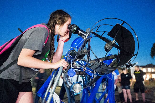News-Register file photo##At a star party in Carlton in 2018, Kendall Stephens peers through the viewfinder of “BigBlue.”