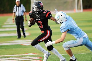 Rusty Rae/News-Register##
Kerby Hartzell sheds a defender on his way to a touchdown against Corvallis Friday at the Jamboree held in McMinnville. Rusty Rae/News-Register##
Kerby Hartzell sheds a defender on his way to a touchdown against Corvallis Friday at the Jamboree held in McMinnville.