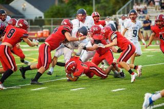 Rusty Rae/News-Register##
The McMinnville defense, led by Mario Nesvig (14) and Austin Carl (55) force a ball-carrier to the turf during Friday’s jamboree against Westview at Wortman Stadium.