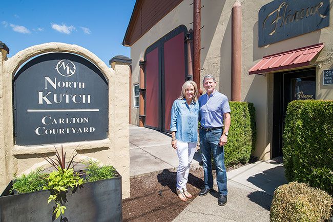 Marcus Larson/News-Register ##
During one of their regular visits to Carlton, Janell and Steve Taylor stand in front of Lobans’ former machine shop and residence, now the Troon Winery tasting room. Steve bought the property in 1994 for his company, American Packaging, and used the office as an art gallery.