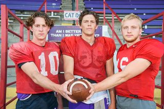 Rusty Rae/News-Register##Either (from left) Blake Eaton, Michael Schutz and Dawson Lieurance, will start at quarterback in the Wildcats first game Saturday. Coach Joseph Smith is keeping his decision under wraps until gametime.
