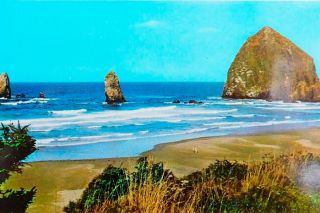 Image: Postcard ## Haystack Rock and The Needles, as seen from the beach south of the rock. Right around the middle of the rock, in this view, is the spot where a convenient little shelf of land once stood, which provided climbers with an easy place to start from. It was blasted away in October 1968 to discourage climbers.