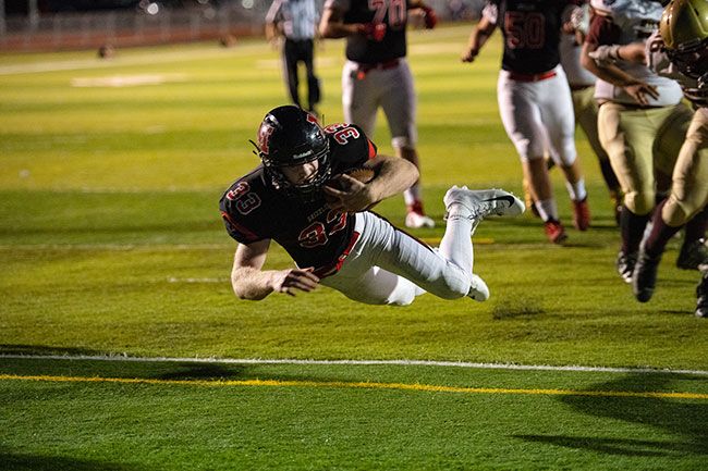 Rusty Rae/News-Register##
Noah Kepler dives into the end zone after making a terrific cut to score McMinnville s first touchdown of the second half, atoning for two first half fumbles in the Grizzlies  41-7 season opening win.