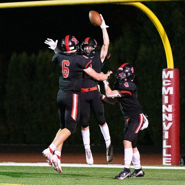 Marcus Larson/News-Register##
Ky Hoskinson (6) and Tyler Mishler (4) celebrate Braden Woods  game-clinching 52-yard touchdown catch during Friday s 19-8 Grizzly win against Ida B. Wells.