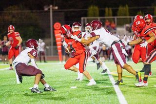 Marcus Larson/For the News-Register##Grizzly back Austin Rapp scored twice Friday night, including this 54-yard tear, despite an opponent grabbing his face mask. McMinnville declined the third-quarter penalty.