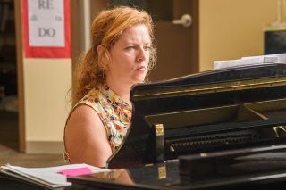 Rusty Rae/News-Register##Karley Herrick Jones, who graduated from McMinnville High School,plays the piano in the choir room at her alma mater, where she now teaches.