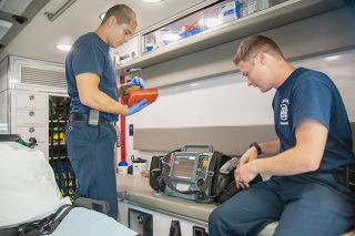 Kirby Neumann-Rea##McMinnville Fire paramedics Israel Pintor, left, and Travis Brenneman examine a defibrillator as they do an equipment checklist inside one of the department ambulances. Increased staffing and upgraded equipment would be among the impacts of the proposed fire district merger. Kirby Neumann-Rea##McMinnville Fire paramedics Israel Pintor, left, and Travis Brenneman examine a defibrillator as they do an equipment checklist inside one of the department ambulances. Increased staffing and upgraded equipment would be among the impacts of the proposed fire district merger.