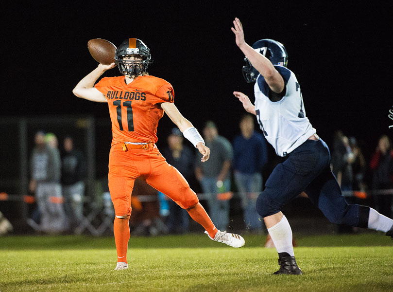 Marcus Larson/News-Register##
Willamina s Kaleb Reid fires a pass as Sheridan s Reilley Dearth pursues.