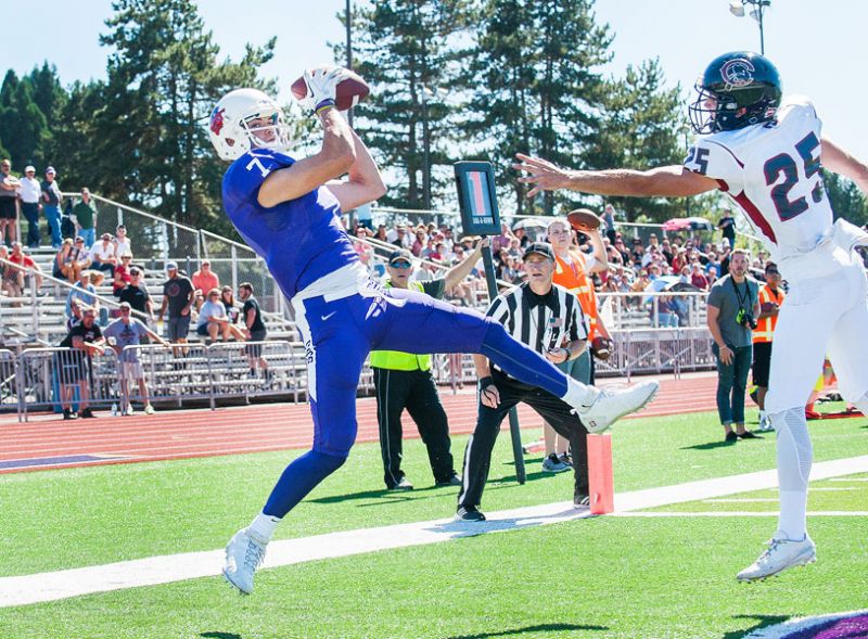 Marcus Larson/News-Register##
Linfield s Johnny Carroll makes a backwards flying catch for a touchdown in the back of the endzone.
