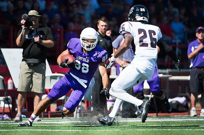 Marcus Larson/News-Register##
Linfield’s leading receiver, Zach Kuzens, turns sharply after making a catch to try and gain a few more yards.
