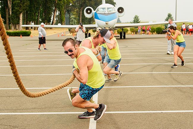 Rusty Rae/News-Register##
Team You Can t Boat With Us hoists the thick rope attached to the NASA jet, and pulls as one while competing in the Special Olympic Plane Pull Saturday at Evergreen