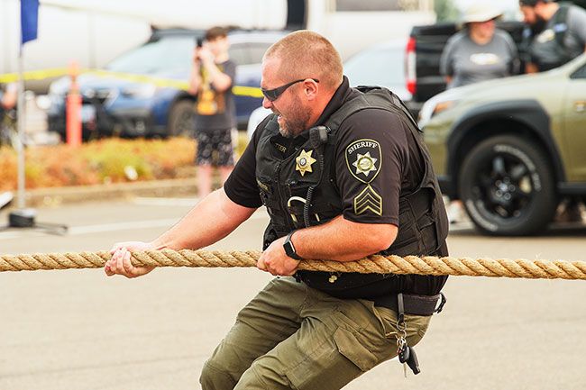 Rusty Rae/News-Register##
Sergeant Jeff Kutter of the Yamhill Sheriff s Department was at the plane pull to assist event organizers, but gave a helping hand to several teams who were struggling to get the 36,000 pound NASA passenger jet moving. Kutter is also an assistant football coach at Yamhill Carlton High School.