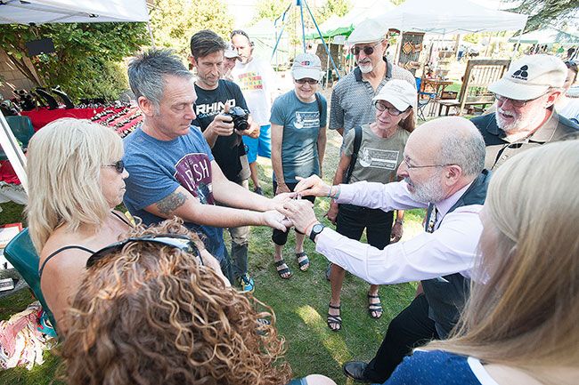 News-Register file photo/Marcus Larson##Mark Siegel wows a crowd with
card tricks during last year’s Carlton Crush celebration. The Delphian School assistant headmaster has been fascinated by magic since his
childhood in Southern California.