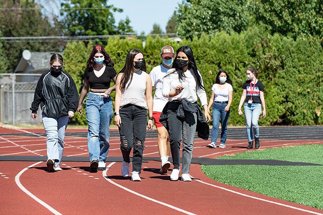 Marcus Larson/News-Register ##
Advanced Language students walk around the McMinnville High School track while discussing ideas for a writing assignment.