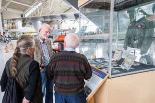 Marcus Larson/News-Register##General Merrill  Tony  McPeak chats with old schoolmate Ted Sieckman and his wife, Arlette, as they look over half the new display honoring the former Air Force chief of staff at the Evergreen Aviation Museum. The display of uniforms and memorabilia takes up two glass cases and includes a Vietnam-era F-100F, like McPeak flew over the Ho Chi Minh Trail.