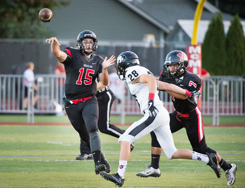 Marcus Larson/News-Register##
McMinnville starting quarterback Samuel DuPuis completes a pass to Colton Smith for the first Grizzly touchdown of the game as Noah Spencer (7) helps with protection on the play.