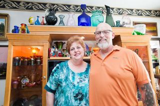 Marcus Larson/News-Register##
Ginny and Randy David in front of their collection of Imperial Iron Cross glassware. They have many collections of their own, and sell vintage items to others under the name G&R Antiques.