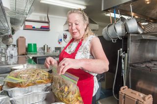 Rusty Rae/News-Register ##
Robin Miguel prepares vegetables at the Soup Kitchen @ St. Barnabas. She said she enjoys the creative challenge afforded by donations from gardeners in the community.
