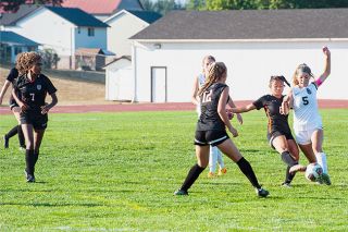 Kirby Neumann-Rea/News-Register##Aggressive play is on display at Yamhill-Carlton’s field as Piper Pellegrino (8) of Yamhill-Carlton and Renika Oliveira (5) of Dayton vie for a 50-50 ball, backed up by Tiearra Braithwaite, left and Kyle Warner (12) of Yamhill-Carlton and, in back, Kya Kearns of Dayton. Kirby Neumann-Rea/News-Register##Aggressive play is on display at Yamhill-Carlton’s field as Piper Pellegrino (8) of Yamhill-Carlton and Renika Oliveira (5) of Dayton vie for a 50-50 ball, backed up by Tiearra Braithwaite, left and Kyle Warner (12) of Yamhill-Carlton and, in back, Kya Kearns of Dayton.