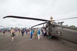 Marcus Larson/News-Register file photo##Chief Warrant Officer 2 Mike Newgard stands on his unit’s Blackhawk helicopter for a better view during last year’s Oregon International Air Show at the McMinnville Airport. Marcus Larson/News-Register file photo##Chief Warrant Officer 2 Mike Newgard stands on his unit’s Blackhawk helicopter for a better view during last year’s Oregon International Air Show at the McMinnville Airport.