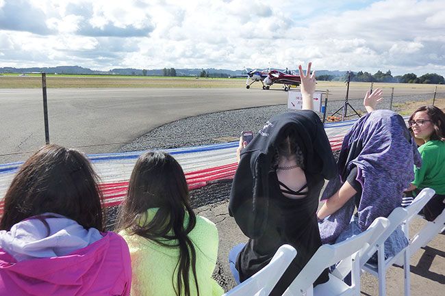 Starla Pointer / News-Register##Fifth-graders wave at  pilot Jeff Boerboon as he taxis his Yak 110 out to the runway for his part of the show.