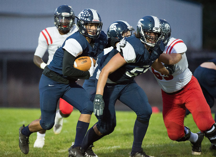 Marcus Larson/News-Register##
Sheridan wide receiver Chris Savoldi (19) carries the ball down field with Brian Flowers (59) leading the way for a big gain.