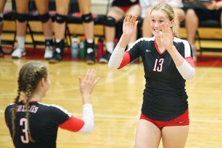 Rockne Roll/News-Register
McMinnville outside hitter Taylor Petersen (13) celebrates a point with Grizzlies setter Montanna Gubrud (3) during Mac’s 3-0 victory over Sprague on Monday night.