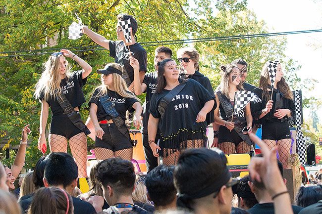 Marcus Larson / News-Register##Seniors wave checkered flags, eliciting roars from onlookers and fellow students.