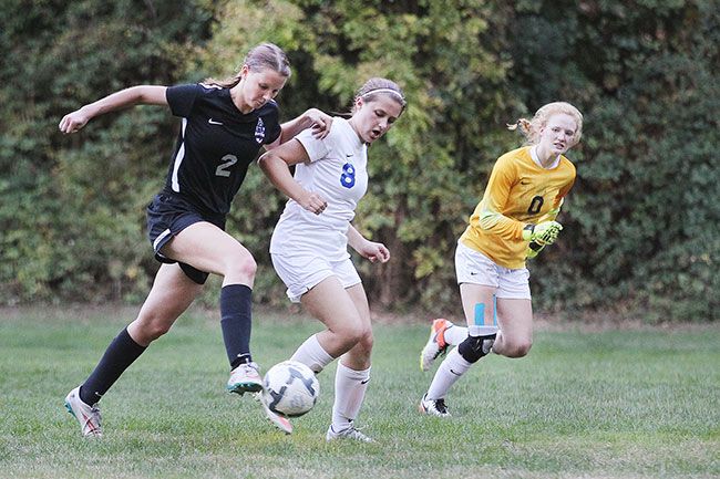 Rockne Roll/News-Register##
Dayton s Lynsey Katzler surges towards the goal in Monday s match between the Pioneers and the Pirates at Western Mennonite School in Perrydale.  Katzler scored all four goals in the Pirates victory.