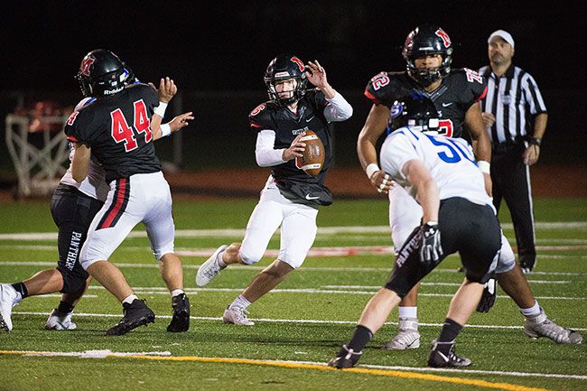 Marcus Larson/News-Register##
McMinnville quarterback Ky Hoskinson attempts to evade the South Medford pass rush.