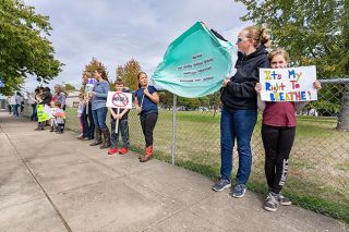 Marcus Larson/News-Register##Parents and children protested masking requirements in Amity schools during a gathering Wednesday on Trade Street.