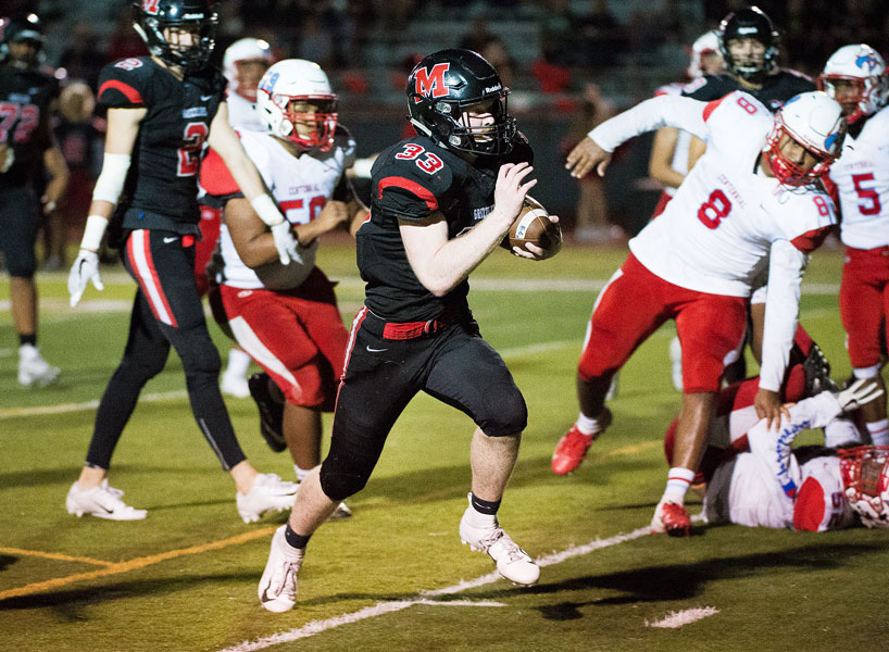 Marcus Larson/News-Register##
McMinnville s Noah Kepler (33) races toward the end zone, scoring a 17-yard touchdown to seal the Grizzlies  41-27 win over Centennial on homecoming night.